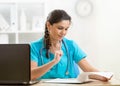 Female doctor writing prescription white sitting at desk in hospital office Royalty Free Stock Photo