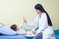 Female doctors perform physical examination on small children on the bed.