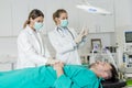 Female doctors preparing patient for intervention Royalty Free Stock Photo