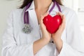 Female doctors's hands holding red heart