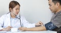 Female doctors use blood pressure monitors and stethoscope to measure pulse Diagnose the patient`s disease in a modern hospital m Royalty Free Stock Photo