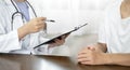 Female doctors who treat patients make an appointment to listen to the results after a physical examination and explain medical