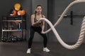 Sportswoman working out with battle ropes in functional training gym Royalty Free Stock Photo