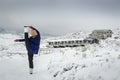 Female doing a standing yoga splits pose in the snow, at Ben Lomond ski field, Tasmania, Australia