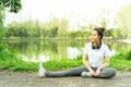 Female doing stretching exercise for legs, Young fitness healthy woman warm up before running or jogging in the park in sunshine Royalty Free Stock Photo