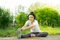 Female doing stretching exercise for legs, Young fitness healthy woman warm up before running or jogging in the park in sunshine Royalty Free Stock Photo