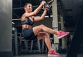 Female doing workouts with trx suspension strips in a gym club. Royalty Free Stock Photo