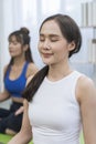 Female doing yoga exercises. Full length of two young sporty women stretching hands in fitness studio Royalty Free Stock Photo