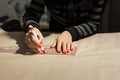 Female dressmaker hands tailor mark drawing on craft paper for making patterns