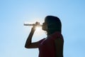 Female drinking water in hot summer - heat stroke concept.