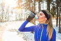 Female drinks water on break from running