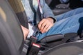 Female Driver Attaching Safety Seat Belt in a Car