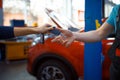 Female driver gives keys to worker in uniform