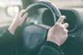 Female driver hands griping steering wheel