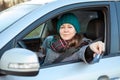 Female driver making cashless payment via credit card inside of her car, stretching hand through the window Royalty Free Stock Photo