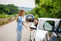 A female driver shouted at a male driver whose car was rear-ended on country road Royalty Free Stock Photo