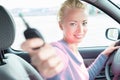 Female driver showing car keys. Young female driving happy about her new car or drivers license.