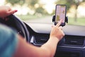 Female driver uses navigation on his mobile phone