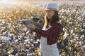 The female drone pilot walks into the field and inspects before the flight.