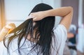 Female drying long hair with dryer,Young asian woman after bath hairbrushing her hair with comb