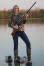 Female Duck Hunter with shotgun and decoys Royalty Free Stock Photo