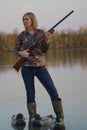 Female Duck Hunter with shotgun and decoys Royalty Free Stock Photo