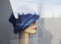 Female dummy with blue woolen hat in display window