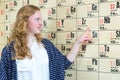 Female dutch student pointing at wall chart with periodic table Royalty Free Stock Photo