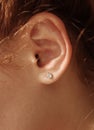 Female ear with diamond earrings