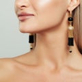 Female Ear with Gold Earrings with Black Pearls Royalty Free Stock Photo