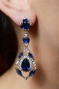 Female ear in jewelry earrings Royalty Free Stock Photo