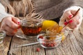 Female eat honey with herbal tea Royalty Free Stock Photo