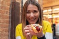 Happy woman eating a hot dog