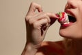 Female eating a strawberry covered in cream