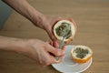 Female eats fresh organic ripe granadilla or yellow passion fruit with a spoon. Exotic fruits, healthy eating concept Royalty Free Stock Photo