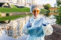 Female ecologist or epidemiologist points to excellent urban water quality Royalty Free Stock Photo