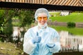 Female ecologist or epidemiologist points to excellent urban water quality Royalty Free Stock Photo