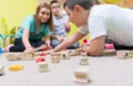 Female educator teaching children to build a train circuit Royalty Free Stock Photo