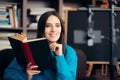 Female Educator Teaching Online Course Holding a Book