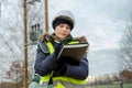 Female electrical engineer writing after examining on the low voltage line