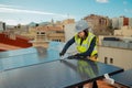 Female electrician engineer installing photovoltaic Solar Panels on city rooftop Royalty Free Stock Photo