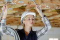 Female electrician fixing ceiling lighting Royalty Free Stock Photo