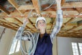 female electrician fixing ceiling lighting Royalty Free Stock Photo