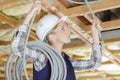 Female electrician fixing ceiling wiring Royalty Free Stock Photo