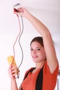 Female electrician fixing lighting Royalty Free Stock Photo