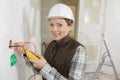 Female electrician installing wall socket