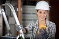 female electrician taking multimeter reading from vintage meter Royalty Free Stock Photo