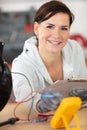 Female electrician testing charge to spotlight Royalty Free Stock Photo