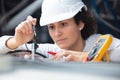 female electrician testing charge to spotlight Royalty Free Stock Photo