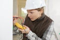 Female electrician testing wall socket Royalty Free Stock Photo